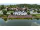 Exterior shot of the clubhouse reflected on a serene pond, surrounded by lush lawns and parking at 28683 Lucero Ln, Wesley Chapel, FL 33543