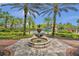 Beautiful community pool with a fountain, palm trees, and a water slide in the background at 28683 Lucero Ln, Wesley Chapel, FL 33543