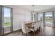 A dining room with an orb chandelier, with access to the lanai overlooking the lake at 28683 Lucero Ln, Wesley Chapel, FL 33543
