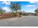 Stone 'Cortona' sign with gated entrance showing brick columns and mature trees within the property at 28683 Lucero Ln, Wesley Chapel, FL 33543