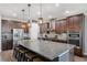 Modern kitchen with stainless appliances, granite countertops and an expansive kitchen island at 28683 Lucero Ln, Wesley Chapel, FL 33543