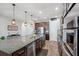 Beautiful kitchen island with seating, stainless appliances and rich brown cabinets at 28683 Lucero Ln, Wesley Chapel, FL 33543