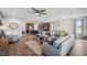 Open-concept living room with a large sectional couch that flows into the modern kitchen at 28683 Lucero Ln, Wesley Chapel, FL 33543
