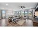 Open living room with a large comfortable couch and a view of the lake at 28683 Lucero Ln, Wesley Chapel, FL 33543