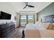 Beautiful main bedroom with wood-look flooring, a ceiling fan and a lovely lake view at 28683 Lucero Ln, Wesley Chapel, FL 33543