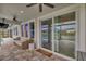 Covered patio featuring comfortable seating, an outdoor ceiling fan, and pool views at 28683 Lucero Ln, Wesley Chapel, FL 33543