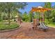 Community playground with slides and play equipment with shade canopies at 28683 Lucero Ln, Wesley Chapel, FL 33543