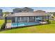 Screened-in pool featuring a blue umbrella and outdoor seating, perfect for relaxation and entertaining at 28683 Lucero Ln, Wesley Chapel, FL 33543