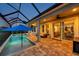 Relaxing screened-in pool area featuring an outdoor seating area and seamless access to the home's interior at 28683 Lucero Ln, Wesley Chapel, FL 33543