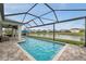 Enjoy this screened-in pool with outdoor entertaining space with picturesque waterfront views at 28683 Lucero Ln, Wesley Chapel, FL 33543