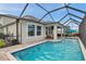 Inviting screened pool and patio combo with a waterfront view to the neighborhood beyond at 28683 Lucero Ln, Wesley Chapel, FL 33543