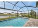 A pristine screened-in pool overlooks a tranquil pond with neighborhood views at 28683 Lucero Ln, Wesley Chapel, FL 33543