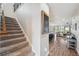 Carpeted staircase with wood accents lead to an open-concept living space at 28683 Lucero Ln, Wesley Chapel, FL 33543