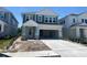 Charming two-story home with light blue siding, white trim, and a spacious two-car garage at 28764 Jujube Rd, Wesley Chapel, FL 33543