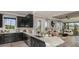 Open-concept kitchen with modern appliances, granite countertops, and island, overlooking the living space at 29536 Zupetta Ln, Wesley Chapel, FL 33545