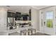 An open kitchen with dark cabinets, a breakfast bar, and stainless steel appliances at 29536 Zupetta Ln, Wesley Chapel, FL 33545