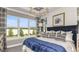 Inviting main bedroom with large windows, tray ceiling, modern lighting, and elegant decor at 29536 Zupetta Ln, Wesley Chapel, FL 33545