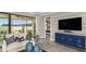 Covered patio space featuring a ceiling fan, neutral sofa, palm fronds and view to the exterior at 29536 Zupetta Ln, Wesley Chapel, FL 33545