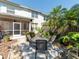 This home boasts a backyard patio surrounded by verdant, tropical plants at 2983 Covewood Pl, Clearwater, FL 33761