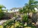The backyard features lush tropical plants and a patio for relaxing at 2983 Covewood Pl, Clearwater, FL 33761