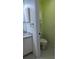 Cozy bathroom featuring tiled floors, a white vanity, and a toilet with a matching cabinet at 2983 Covewood Pl, Clearwater, FL 33761