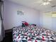 Cozy bedroom featuring light purple walls, carpet flooring and closet at 2983 Covewood Pl, Clearwater, FL 33761