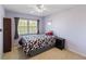Well-lit bedroom with a ceiling fan, window, neutral carpet and walls at 2983 Covewood Pl, Clearwater, FL 33761