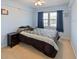 Comfortable bedroom with neutral carpet, closet space, and a large window at 2983 Covewood Pl, Clearwater, FL 33761