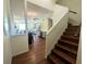 Inviting foyer featuring hardwood floors, staircase, and open access to the living and dining areas at 2983 Covewood Pl, Clearwater, FL 33761