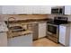 Bright kitchen featuring granite countertops, stainless steel appliances, and tile flooring at 2983 Covewood Pl, Clearwater, FL 33761