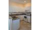 Well-maintained kitchen featuring white cabinets, granite countertops, and modern appliances at 2983 Covewood Pl, Clearwater, FL 33761