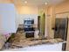 Modern kitchen featuring stainless steel appliances and granite countertops at 2983 Covewood Pl, Clearwater, FL 33761