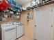 Well-equipped laundry room with shelving, washer, dryer, and ample storage space at 2983 Covewood Pl, Clearwater, FL 33761