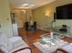Cozy living room showcasing hardwood floors, modern furnishings, and a large flat-screen TV at 2983 Covewood Pl, Clearwater, FL 33761
