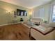 Comfortable living room with hardwood floors, TV, and a view of the outdoor area at 2983 Covewood Pl, Clearwater, FL 33761