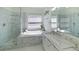 Elegant primary bathroom featuring a soaking tub, frameless shower, and dual sink vanity at 2983 Covewood Pl, Clearwater, FL 33761