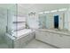 Elegant primary bathroom featuring a soaking tub, frameless shower, and dual sink vanity at 2983 Covewood Pl, Clearwater, FL 33761