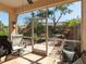 The screened porch leads to a meticulously landscaped backyard at 2983 Covewood Pl, Clearwater, FL 33761