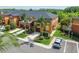 Aerial view of townhome community with lakes and lush greenery, showcasing community layout at 30130 Mossbank Dr, Wesley Chapel, FL 33543