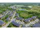 Beautiful aerial view of the townhome community, showcasing surrounding lakes and landscaping at 30130 Mossbank Dr, Wesley Chapel, FL 33543