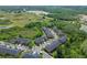 Aerial view of townhomes showing the roofs, parking, and surrounding greenery at 30130 Mossbank Dr, Wesley Chapel, FL 33543