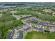 Aerial view of multiple townhomes showing their roofs, landscaping, and surrounding trees at 30130 Mossbank Dr, Wesley Chapel, FL 33543