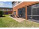 View of the backyard featuring a cozy patio with outdoor seating and screened in lanai at 30130 Mossbank Dr, Wesley Chapel, FL 33543