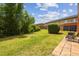 Expansive backyard with lush lawn, mature landscaping, and a patio area for outdoor enjoyment at 30130 Mossbank Dr, Wesley Chapel, FL 33543