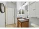 Cozy bathroom with wood cabinets, white sink and medicine cabinet at 30130 Mossbank Dr, Wesley Chapel, FL 33543