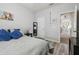 Comfortable bedroom featuring a bed with blue pillows and neutral beach decor at 30130 Mossbank Dr, Wesley Chapel, FL 33543