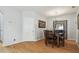 Cozy dining room with wooden table and chairs, decorative mirror, and hardwood flooring at 30130 Mossbank Dr, Wesley Chapel, FL 33543