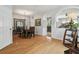 Dining room with hardwood floors, chandelier, and decorative mirror, with views into other rooms at 30130 Mossbank Dr, Wesley Chapel, FL 33543
