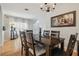 Dining room with hardwood floors, chandelier, and wooden furniture that connects to the living room at 30130 Mossbank Dr, Wesley Chapel, FL 33543