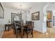 Inviting dining room with wood furniture, chandelier, and a view into the kitchen and living area at 30130 Mossbank Dr, Wesley Chapel, FL 33543